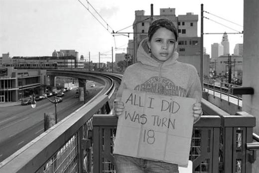 Girl holding a sign that reads 